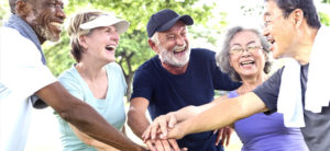group of diverse seniors working out happily together