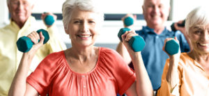 Seniors using weights in a retirement home